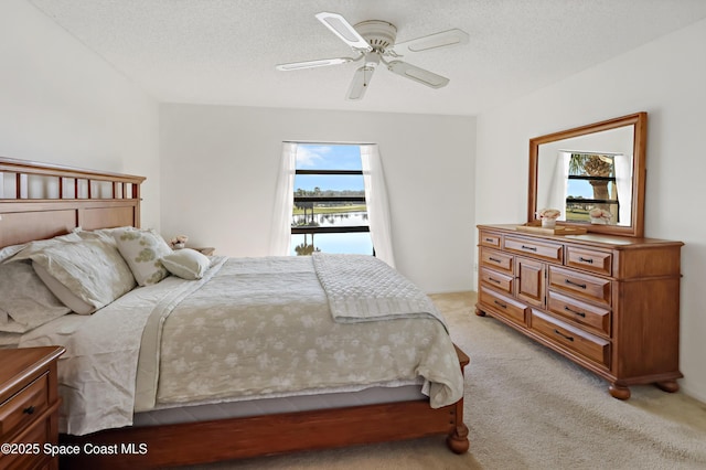 11 Plantation Dr Unit 201, Vero Beach, FL 32966 - carpeted bedroom featuring ceiling fan and a textured ceiling