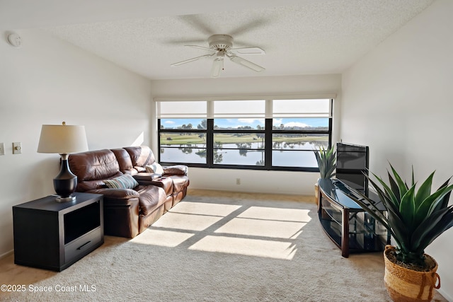 11 Plantation Dr Unit 201, Vero Beach, FL 32966 - living room with ceiling fan, light carpet, and a textured ceiling