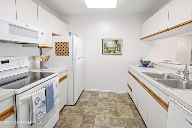11 Plantation Dr Unit 201, Vero Beach, FL 32966 - kitchen featuring white cabinetry, white appliances, a skylight, and sink