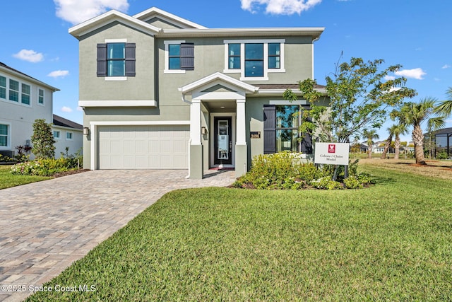 view of front of property with a garage and a front yard