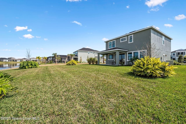 2496 Kamin Dr S, Melbourne, FL 32940 - rear view of property with a water view and a lawn