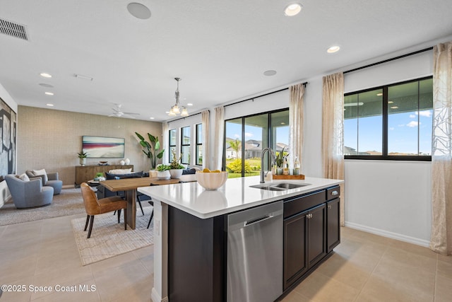 2496 Kamin Dr S, Melbourne, FL 32940 - kitchen featuring light tile patterned flooring, decorative light fixtures, sink, a kitchen island with sink, and stainless steel dishwasher