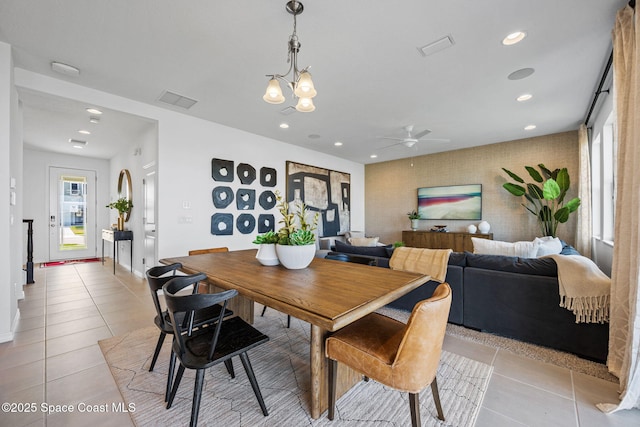 2496 Kamin Dr S, Melbourne, FL 32940 - dining area with ceiling fan with notable chandelier and light tile patterned floors
