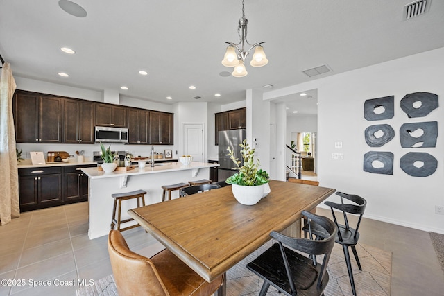 2496 Kamin Dr S, Melbourne, FL 32940 - dining area featuring an inviting chandelier, light tile patterned floors, and sink