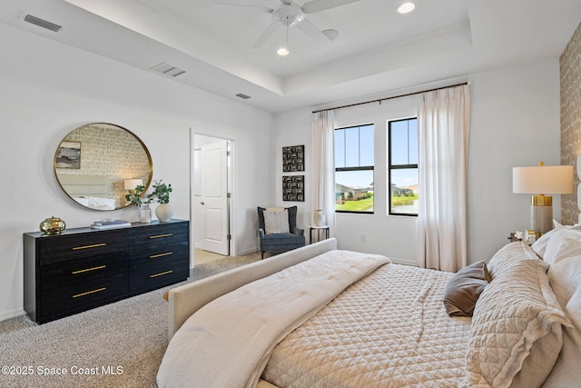 2496 Kamin Dr S, Melbourne, FL 32940 - bedroom with ceiling fan, a raised ceiling, and light carpet