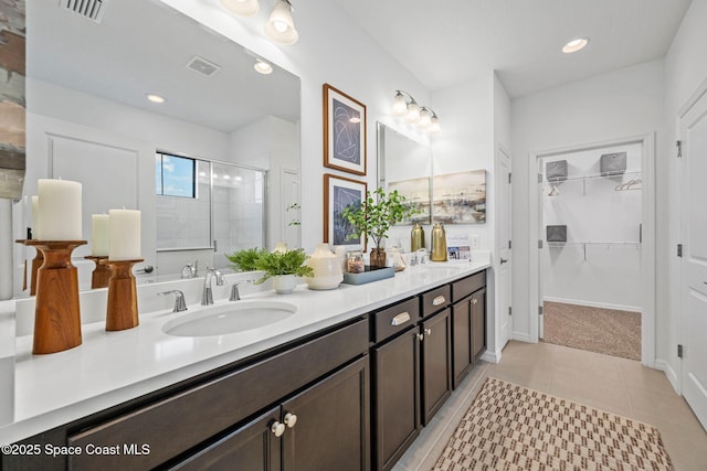 2496 Kamin Dr S, Melbourne, FL 32940 - bathroom with vanity, tile patterned flooring, and a shower with shower door
