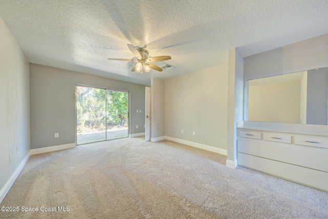 unfurnished room with light colored carpet, a textured ceiling, and ceiling fan