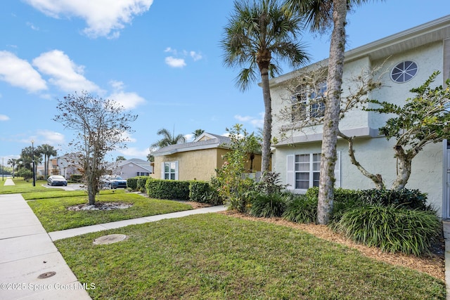 view of property exterior with a lawn