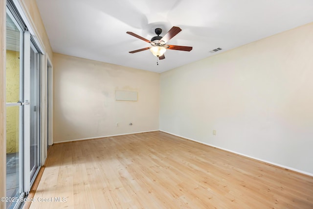 spare room featuring ceiling fan, light hardwood / wood-style flooring, and a wealth of natural light