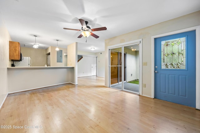 unfurnished living room featuring light hardwood / wood-style flooring and ceiling fan