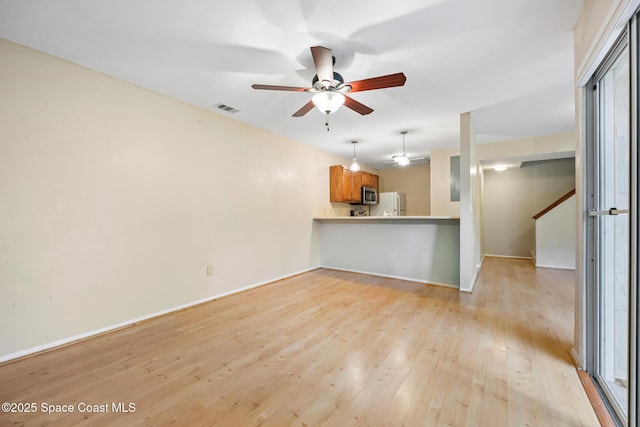 unfurnished living room with ceiling fan and light hardwood / wood-style floors