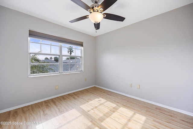 spare room with ceiling fan and light wood-type flooring