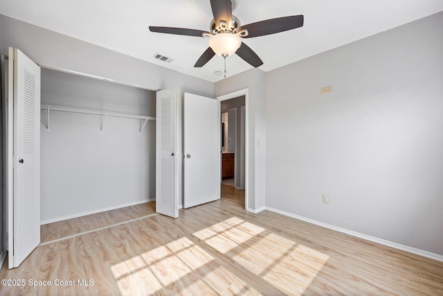 unfurnished bedroom featuring light hardwood / wood-style flooring, a closet, and ceiling fan