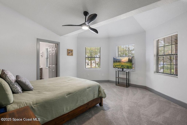 bedroom featuring ensuite bathroom, vaulted ceiling, carpet flooring, and ceiling fan