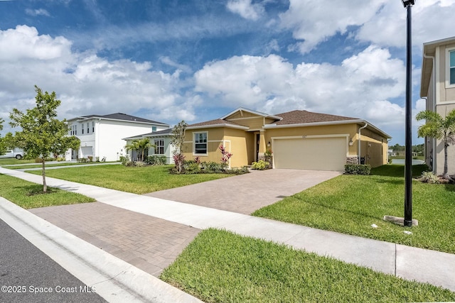 687 Veridian Cir NW, Palm Bay, FL 32907 - view of front of home with decorative driveway, stucco siding, a front yard, a garage, and stone siding