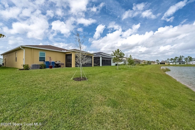 view of yard with central AC unit and a lanai