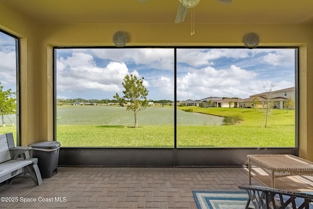 sunroom with a water view and a wealth of natural light