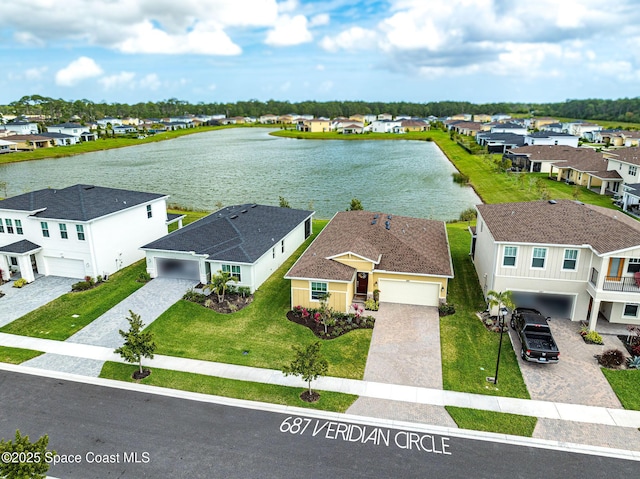 drone / aerial view with a water view and a residential view