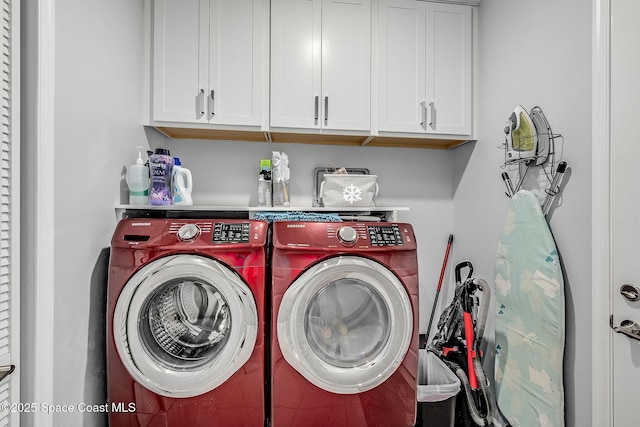 laundry area with washer and clothes dryer and cabinet space