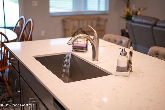 interior details featuring light stone countertops and a sink