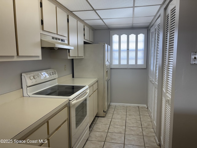 kitchen featuring white electric stove, white cabinetry, a paneled ceiling, and light tile patterned floors