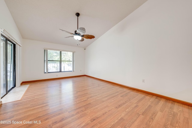 unfurnished room featuring lofted ceiling, light wood finished floors, ceiling fan, and baseboards