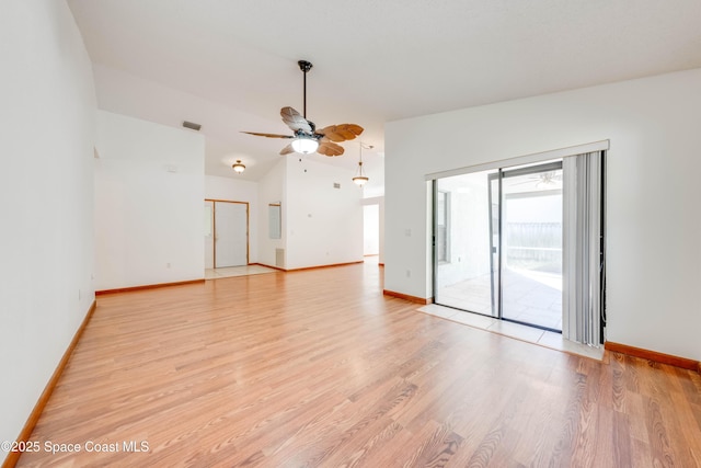 unfurnished room featuring light wood-type flooring, baseboards, visible vents, and lofted ceiling