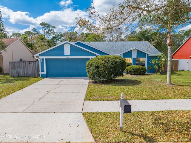 view of front of property featuring an attached garage, concrete driveway, a front yard, and fence