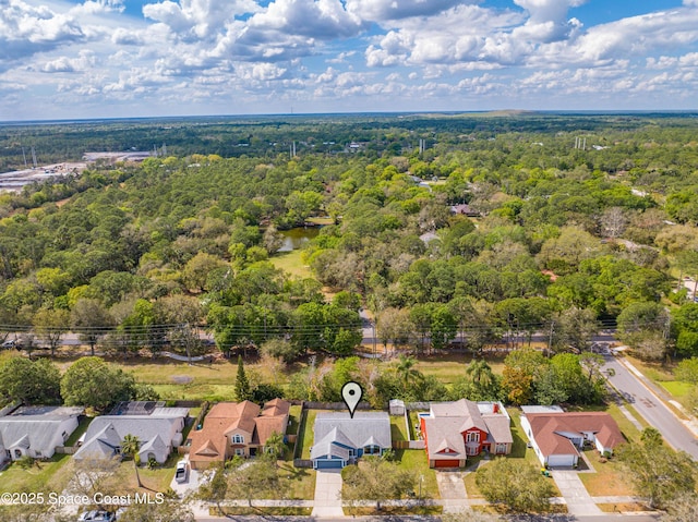 drone / aerial view with a forest view and a residential view