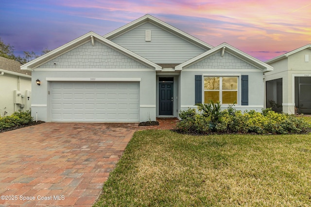 view of front of home with a garage and a yard