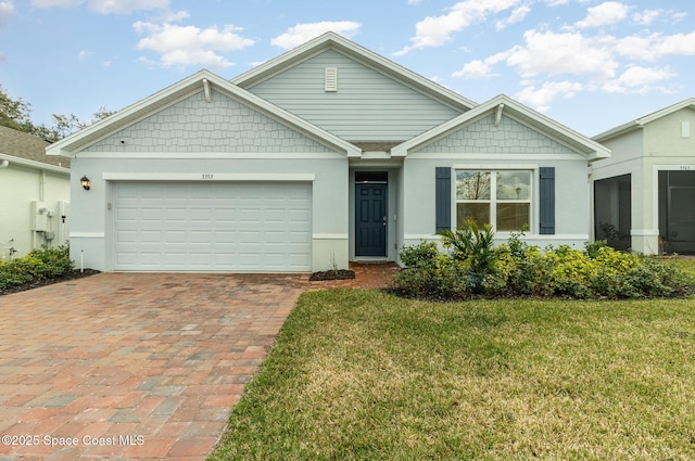 view of front of house with a garage and a front yard