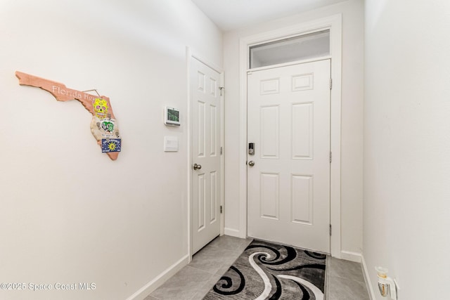 entryway with light tile patterned flooring