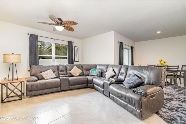 living room with light tile patterned floors, a textured ceiling, and ceiling fan