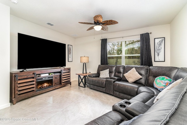 tiled living room featuring ceiling fan