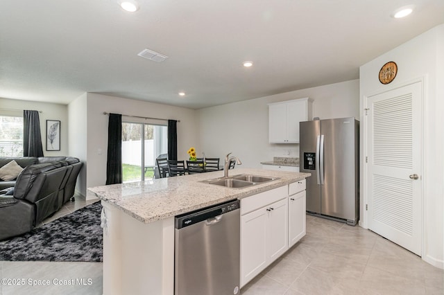 kitchen featuring sink, a center island with sink, white cabinets, and appliances with stainless steel finishes