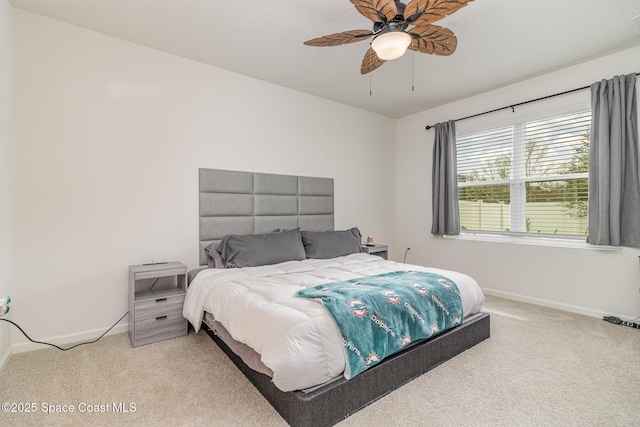 bedroom with light carpet and ceiling fan