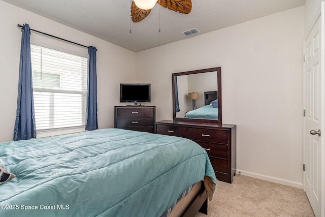 bedroom with light carpet and ceiling fan