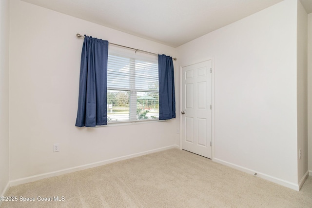 unfurnished room featuring light carpet