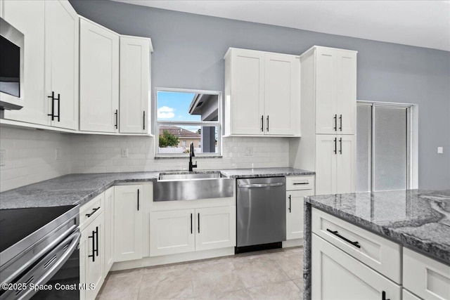 kitchen featuring white cabinetry, sink, tasteful backsplash, and stainless steel appliances