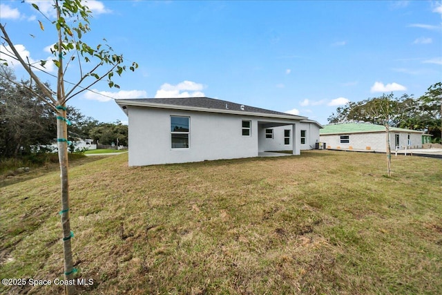 rear view of property with a lawn