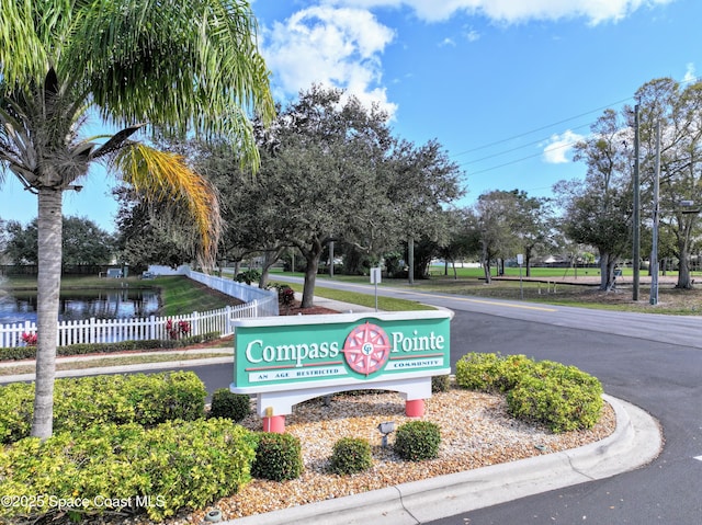 community / neighborhood sign featuring a water view