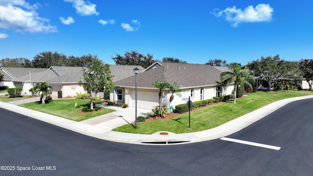 ranch-style home with a garage and a front lawn