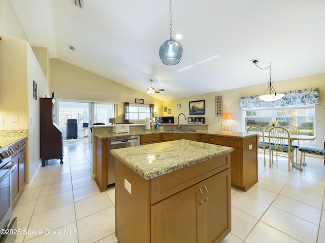 kitchen with pendant lighting, stainless steel appliances, and a kitchen island