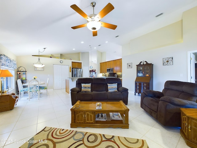 tiled living room with ceiling fan and high vaulted ceiling