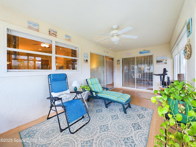 sunroom featuring ceiling fan