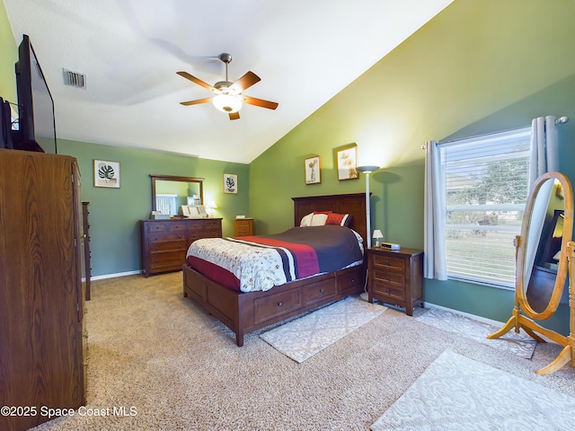 carpeted bedroom with vaulted ceiling and ceiling fan