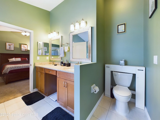 bathroom featuring vanity, tile patterned floors, and toilet