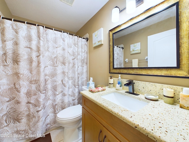 bathroom featuring vanity, tile patterned flooring, and toilet