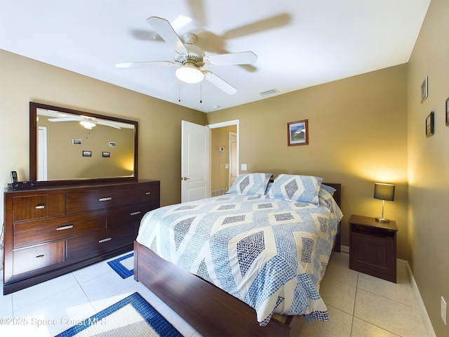 bedroom with ceiling fan and light tile patterned floors