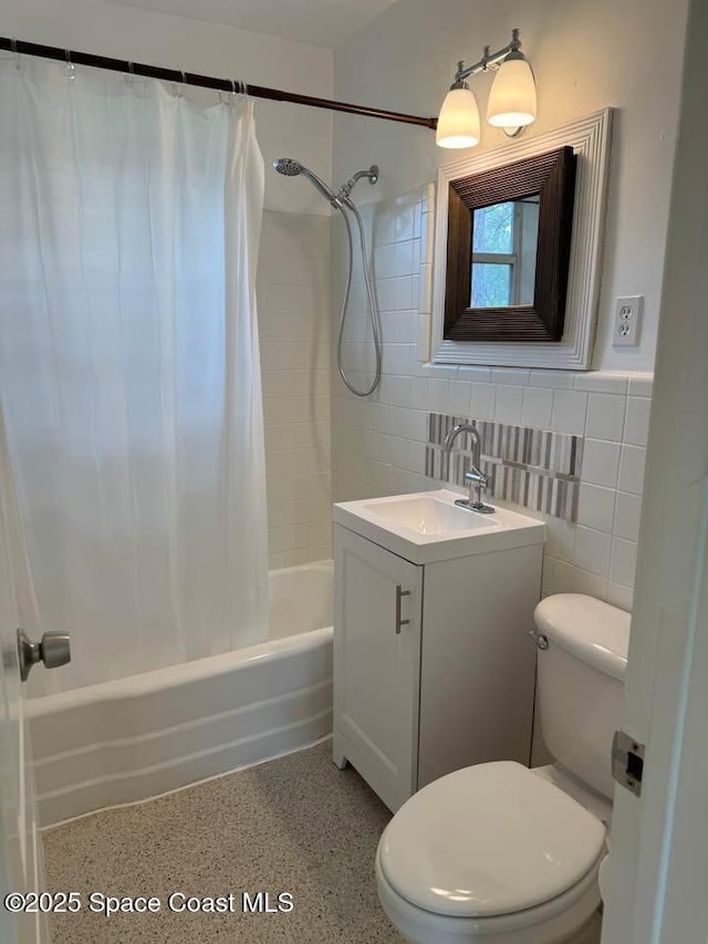 full bathroom with tile walls, vanity, shower / bath combination with curtain, and toilet